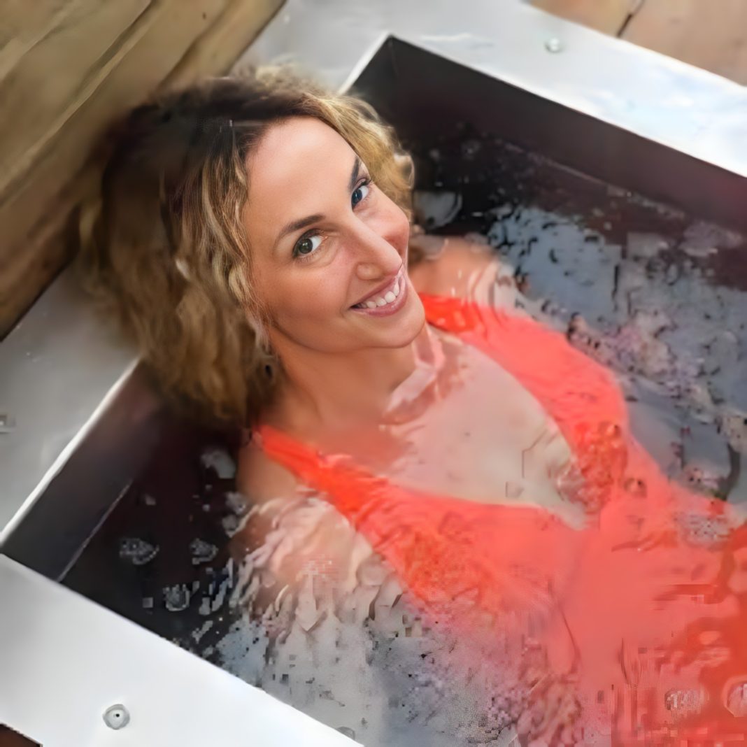 Kristin Weitzel in an ice bath demonstrating a cold plunge protocol for women with Wellpower breathwork.